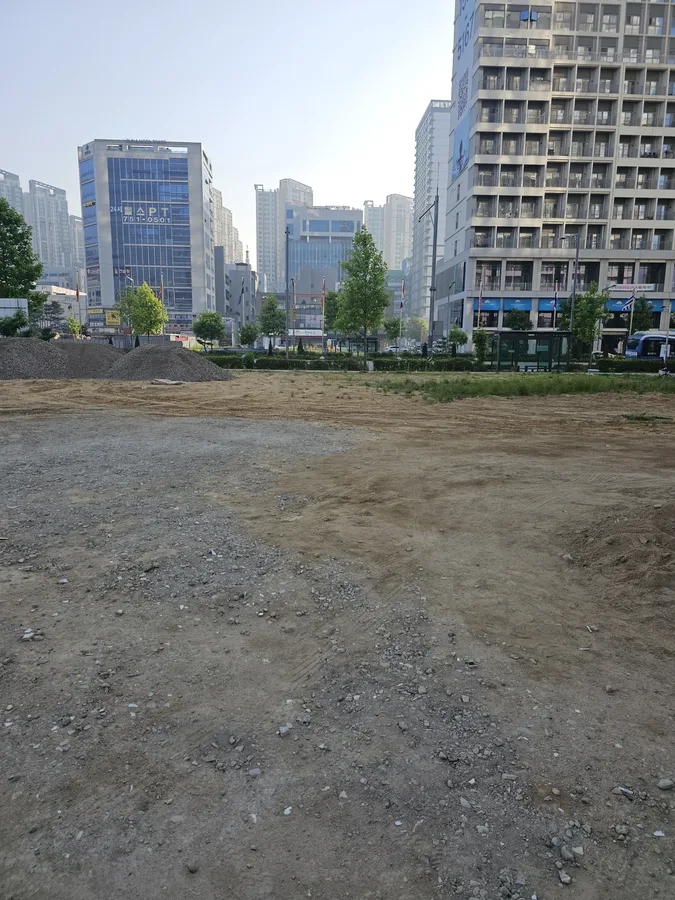 정지작업 전 자재가 쌓여 있는 도심 공터 부지 전경